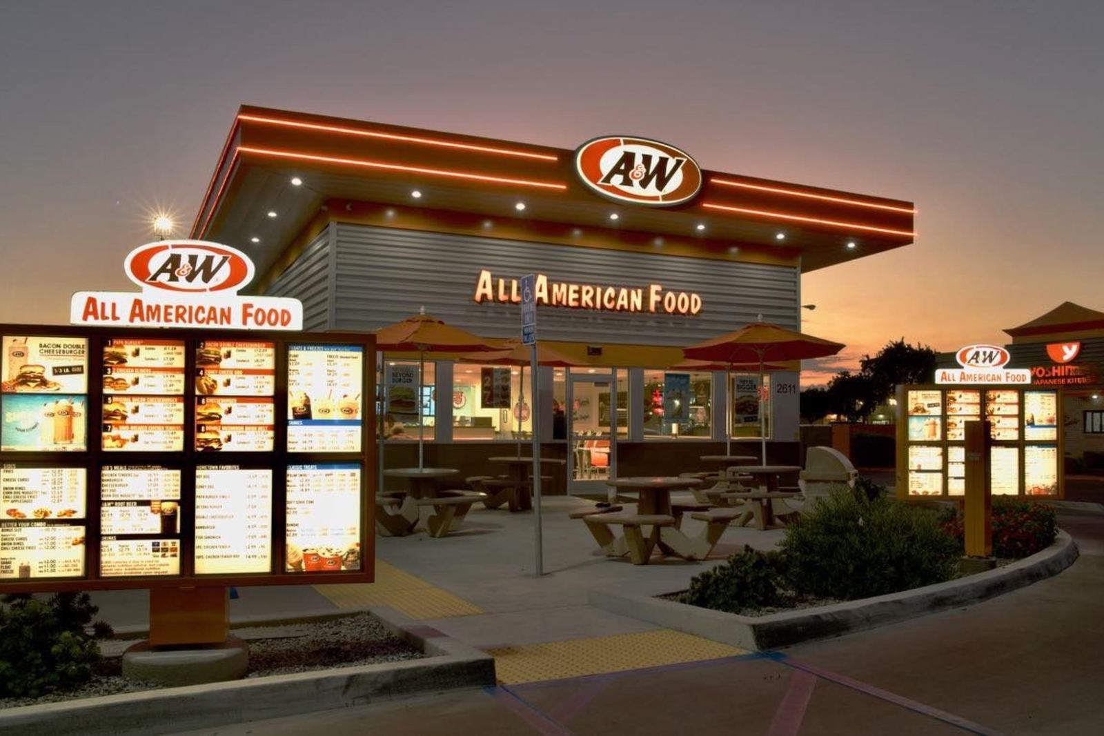 An A&W restaurant glowing at dusk